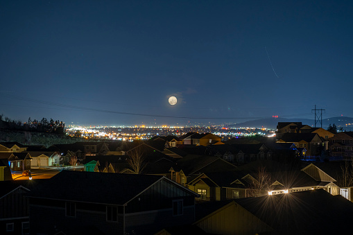 View of downtown Spokane and the Spokane Valley illuminated at night from a hilltop housing development in Liberty Lake, Washington, USA.