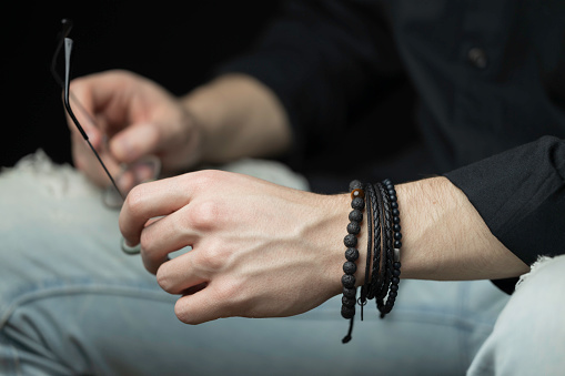 young man posing with bracelets