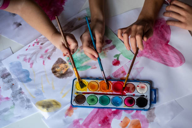 istock Children hands coloring with water colors 1371997045