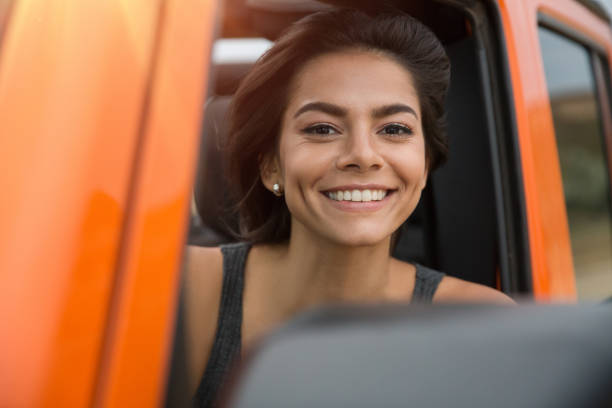 istock Happy smiling woman driving a jeep 1371998335