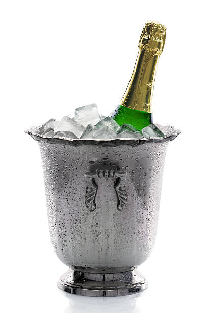 Champagne bottle in a silver bucket with ice stock photo