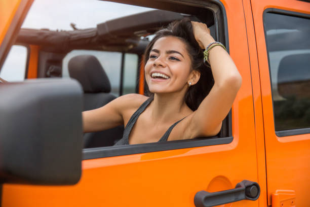 istock Happy woman driving a car 1371999204