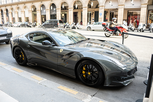 Paris, France - 13 February 2022: A Ferrari F12 tdf in gray color in a street of Paris, France