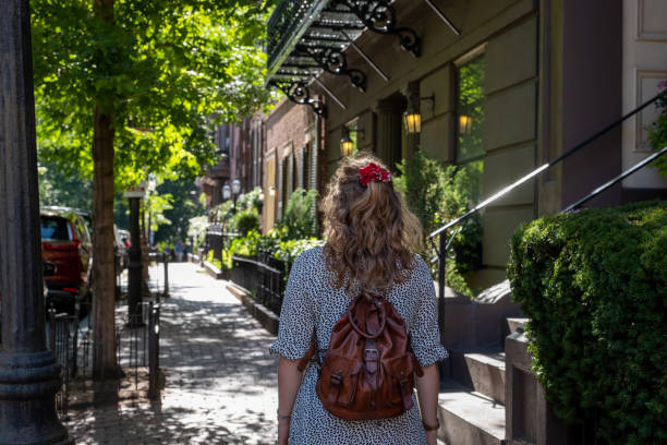 istock Young woman walking through suburban Boston 1372001417