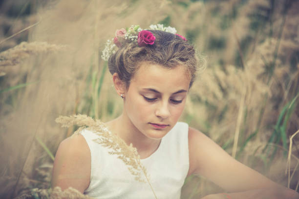 little girl with a flower wreath on her head.