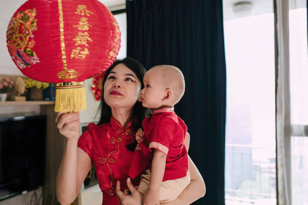 istock asian mother carrying her baby during imlek celebration 1372002199
