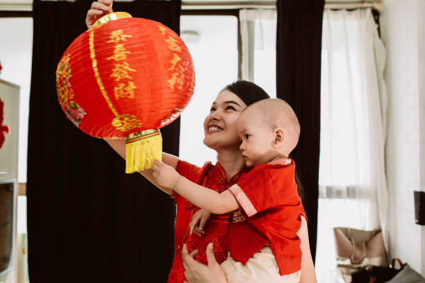 istock asian mother carrying her baby during imlek celebration 1372002211