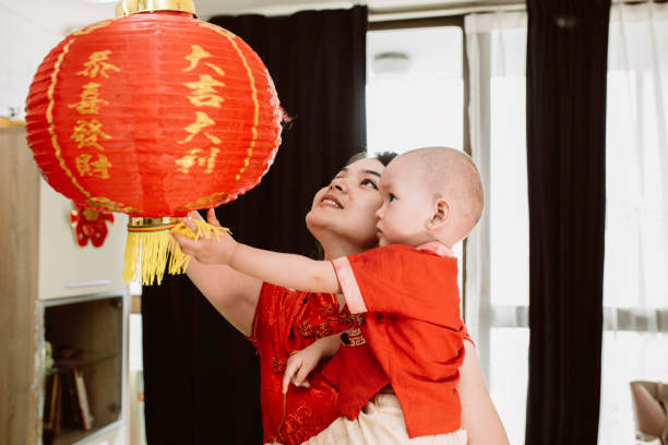 istock asian mother carrying her baby during imlek celebration 1372002217