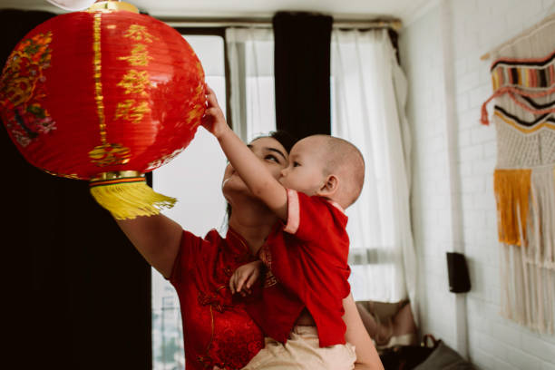 istock asian mother carrying her baby during imlek celebration 1372002218