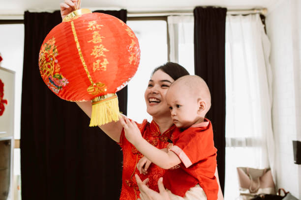 istock asian mother carrying her baby during imlek celebration 1372002221