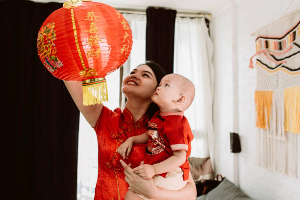 istock asian mother carrying her baby during imlek celebration 1372002237