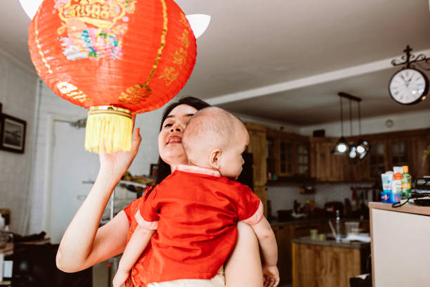 istock asian mother carrying her baby during imlek celebration 1372002243