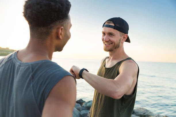 istock Two smiling sportsmen resting after running workout 1372002561