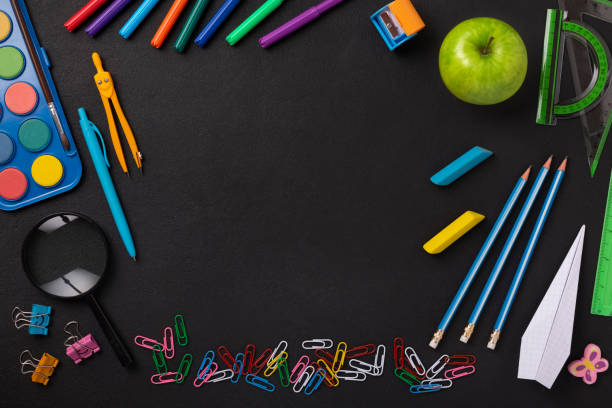 istock Black chalkboard school background with school supplies 1372002610