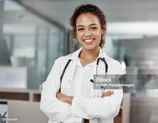 Cropped Portrait Of An Attractive Young Female Doctor Standing With Her Arms Folded In The Office Stock Photo - Download Image Now