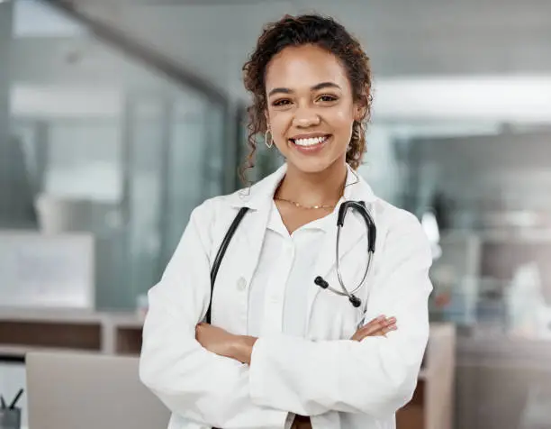Photo of Cropped portrait of an attractive young female doctor standing with her arms folded in the office