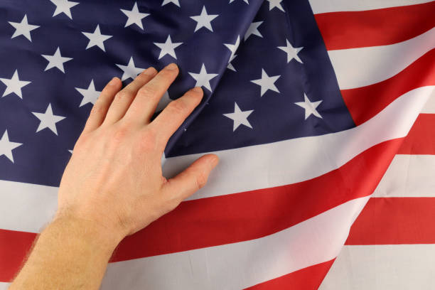 istock USA silk and hand flag 1372004272