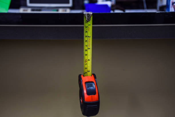 istock measuring instrument Yellow-red measuring tape, hanging, hanging vertically.. 1372005295