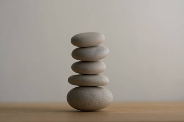 istock Stone cairn on white background, five stones tower, simple poise stones, simplicity harmony and balance, rock zen 1372005384