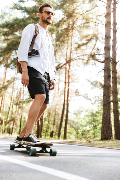 istock Attractive man on skateboard outdoors 1372005505