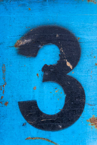 istock Number 3 in black paint on an old blue iron surface with rust texture and traces of dirt. 1372005521