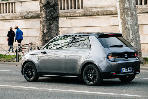 Paris, France - 13 February 2022: An Honda E compact electric car in a street of Paris, France