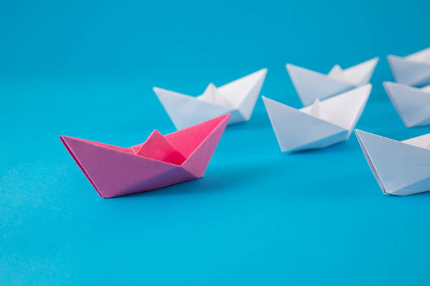 istock Red Paper Boat Leading Other Boats 1372007615