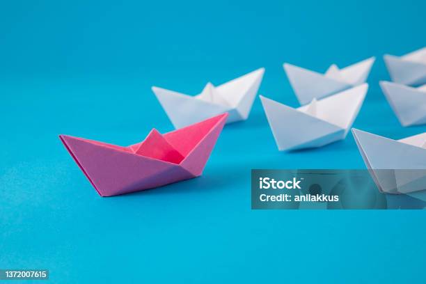 Red Paper Boat Leading Other Boats Stock Photo - Download Image Now - Origami, Leadership, Blue