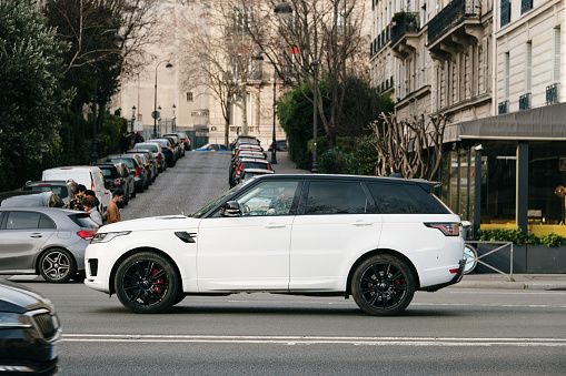 Paris, France - 13 February 2022: A side view of a white Range rover Sport in a street of Paris, France