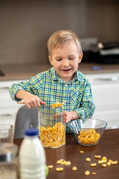 istock Focused cute kid making his morning meal 1372007721