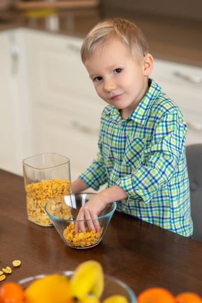 istock Calm kid making his breakfast in the kitchen 1372007722