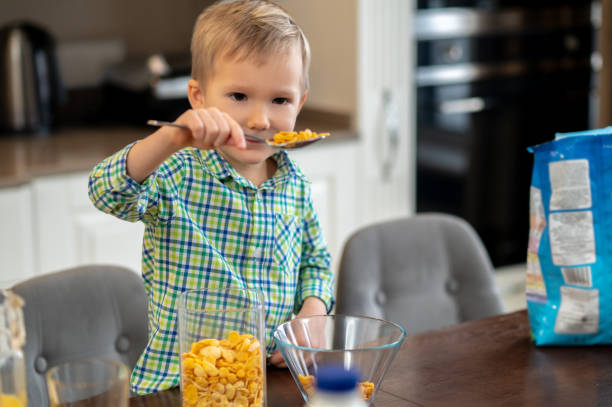 istock Little boy examining ingredients for his oatmea 1372007726