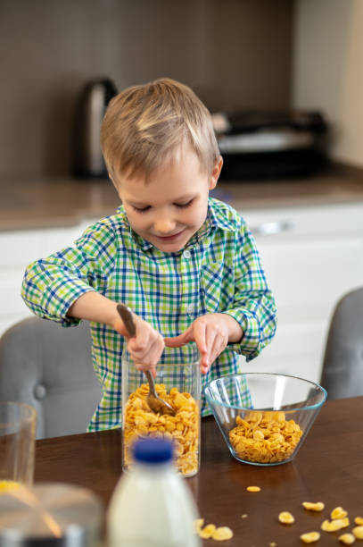 istock Joyous child scooping ingredients for an oatmeal dish 1372007730