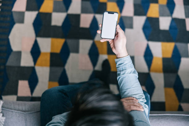 istock Close up of man using smartphone at home 1372014045