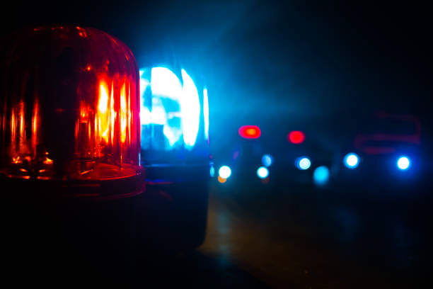 Police car blue and red round vintage siren in dark. Rotating retro style police siren in dark. stock photo