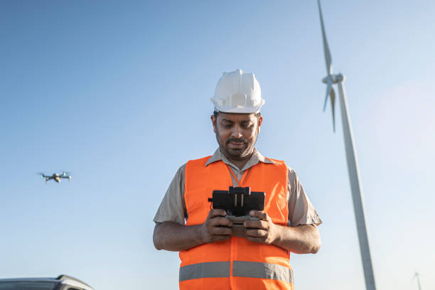 istock Portraits of electrical engineer/technician operating an inspection drone in wind farm park 1372014434