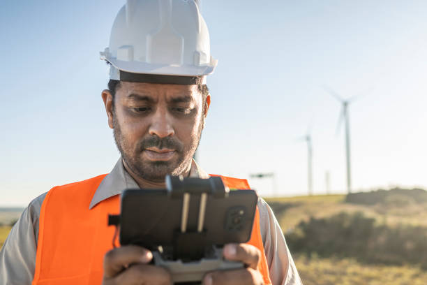 istock Portraits of electrical engineer/technician operating an inspection drone in wind farm park 1372014541