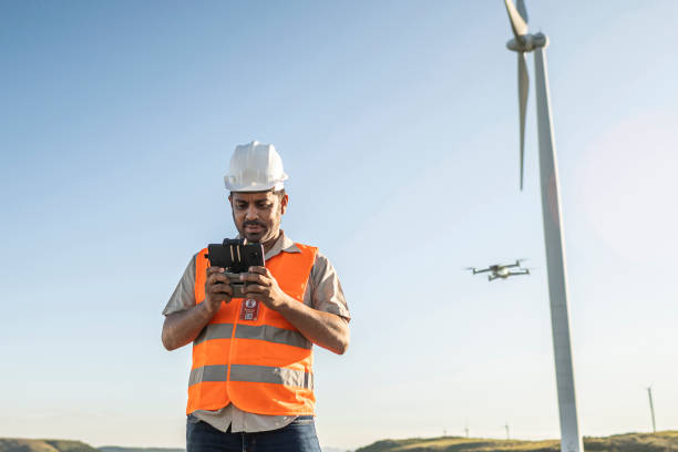 istock Portraits of electrical engineer/technician operating an inspection drone in wind farm park 1372015112