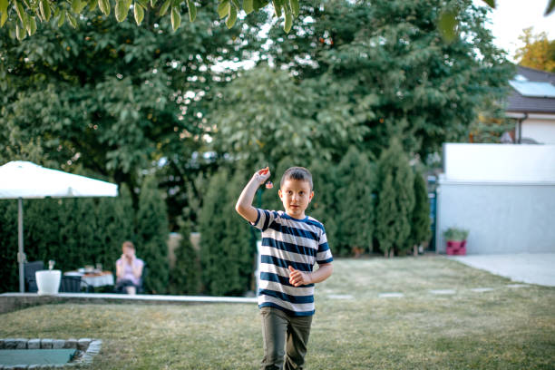 istock Kids playing darts in the back yard 1372015351