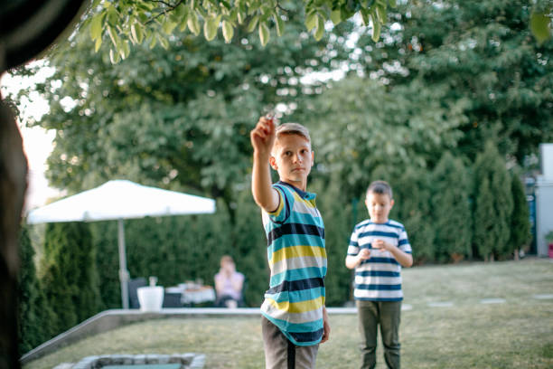 istock Kids playing darts in the back yard 1372015386