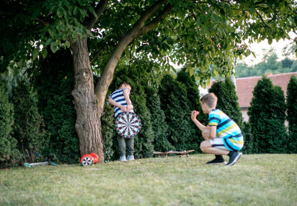 istock Kids playing darts in the back yard 1372015454