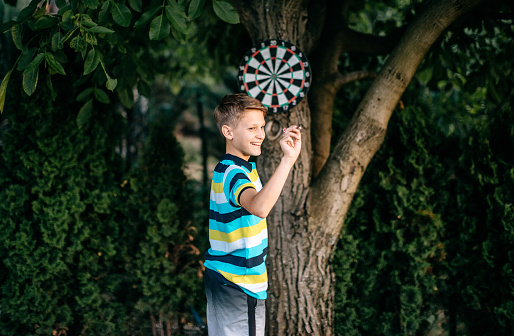 Boy aiming with darts