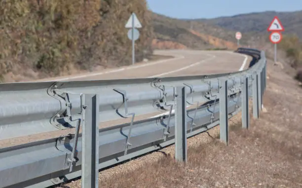 Guardrails poles covered crash-absorber beam. Roadside view. Motorists safety concept