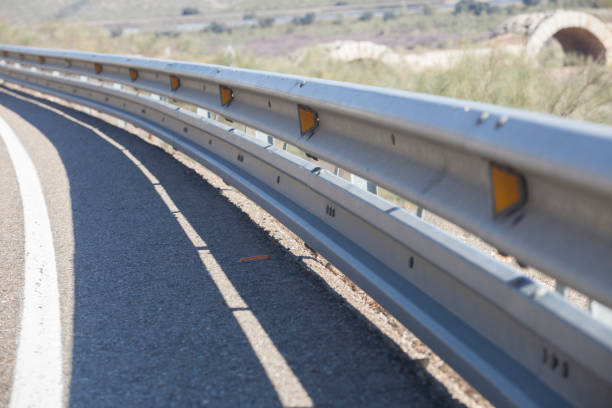 Guardrails poles covered crash-absorber beam. Shoulder view. Motorists safety concept