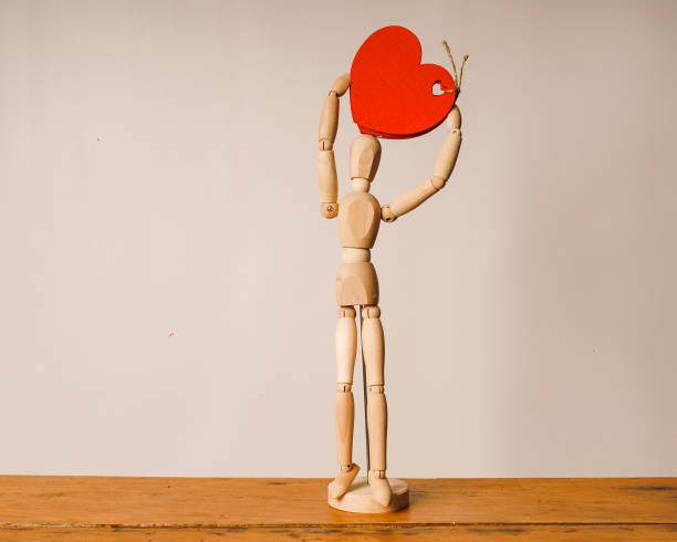 istock wooden mannequin with red heart 1372016498