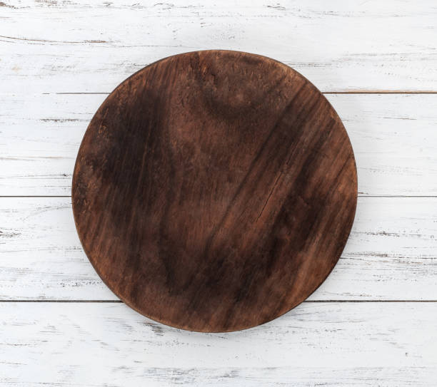 istock Empty round wooden board with copy space over wooden table 1372016676