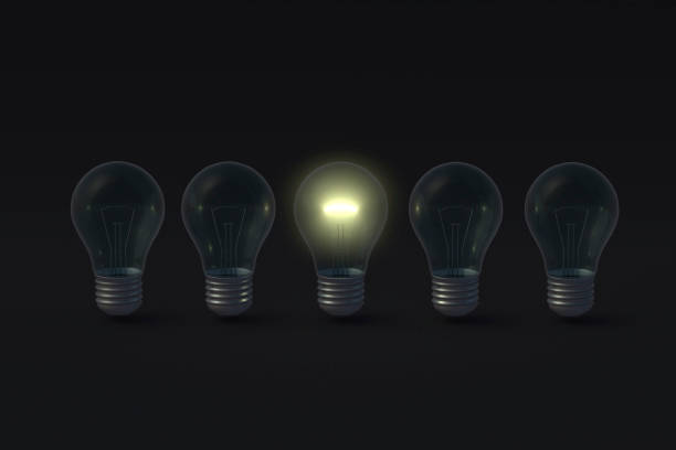 istock Row of light bulbs and one glowing on black background. 3d render 1372016815