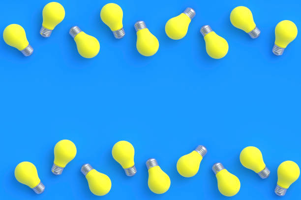 istock Rows of yellow light bulbs on blue background. Top view. Copy space. 3d render 1372016816