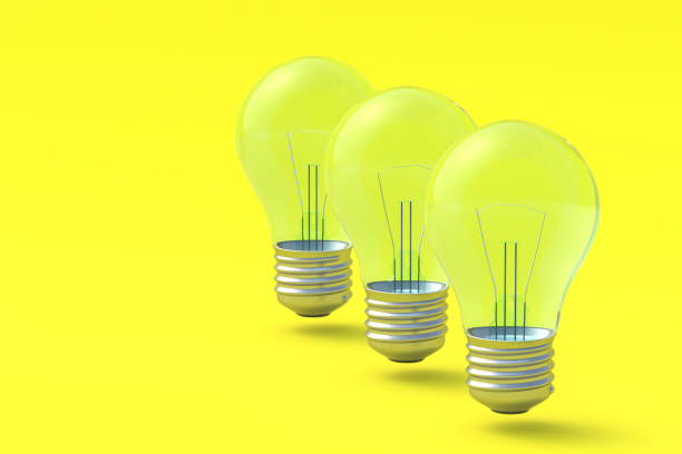 istock Row of three light bulbs on yellow background. Copy space. 3d render 1372016819