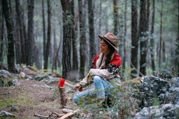 istock Woman Chopping Wood for Campfire 1372018021